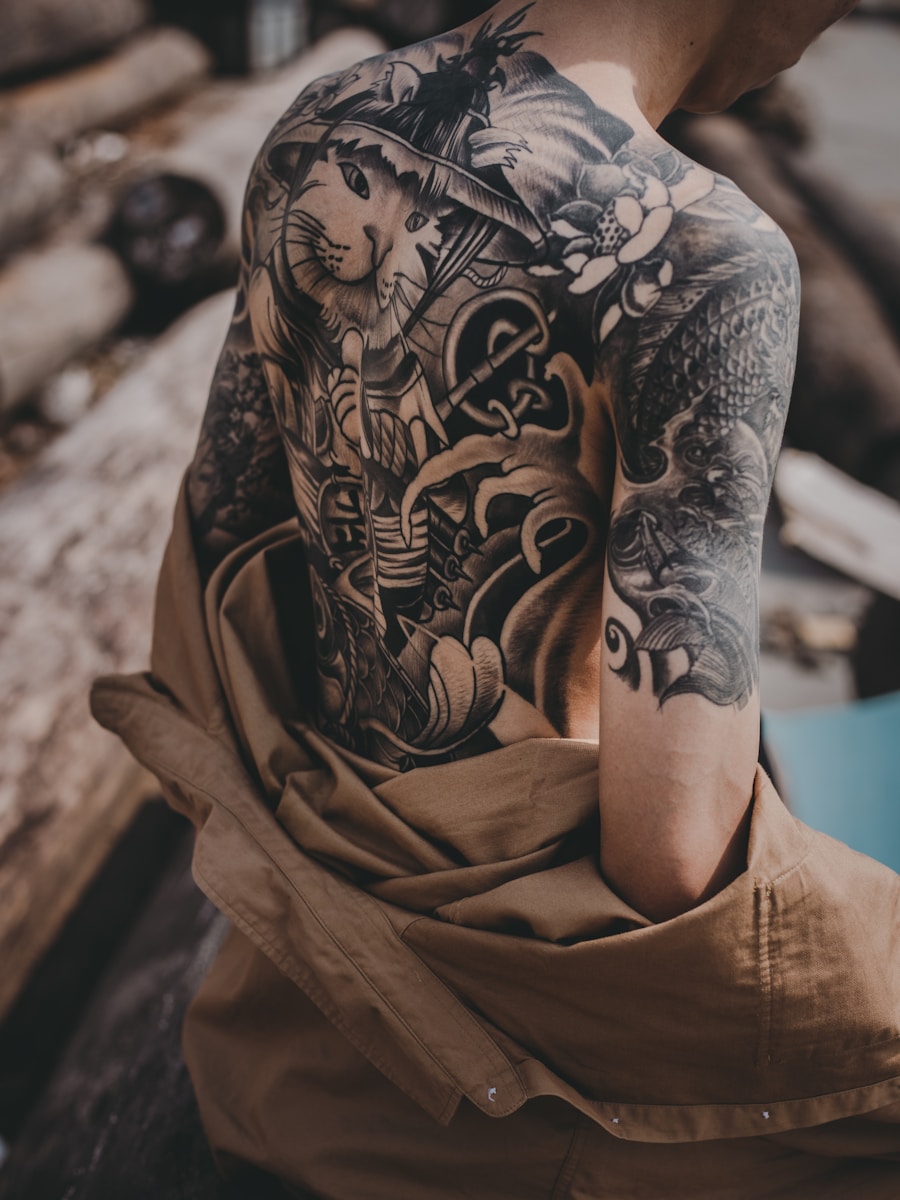 Large illustrative tattoo work across a shoulder and back